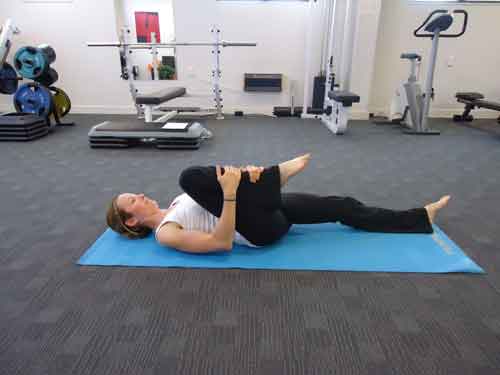 Single-leg-knee-to-chest stretch lying down
