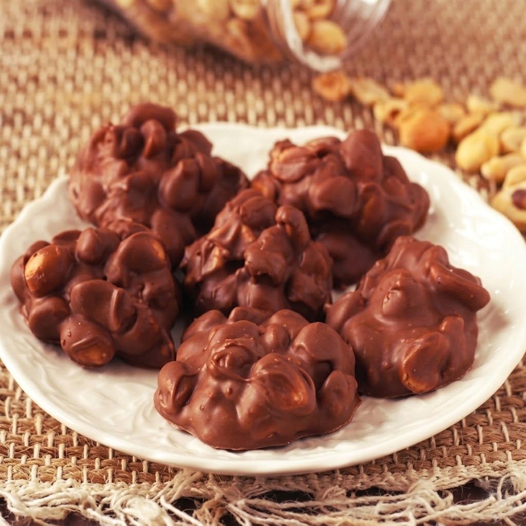 Chocolate peanut crockpot candy cooling on wax paper