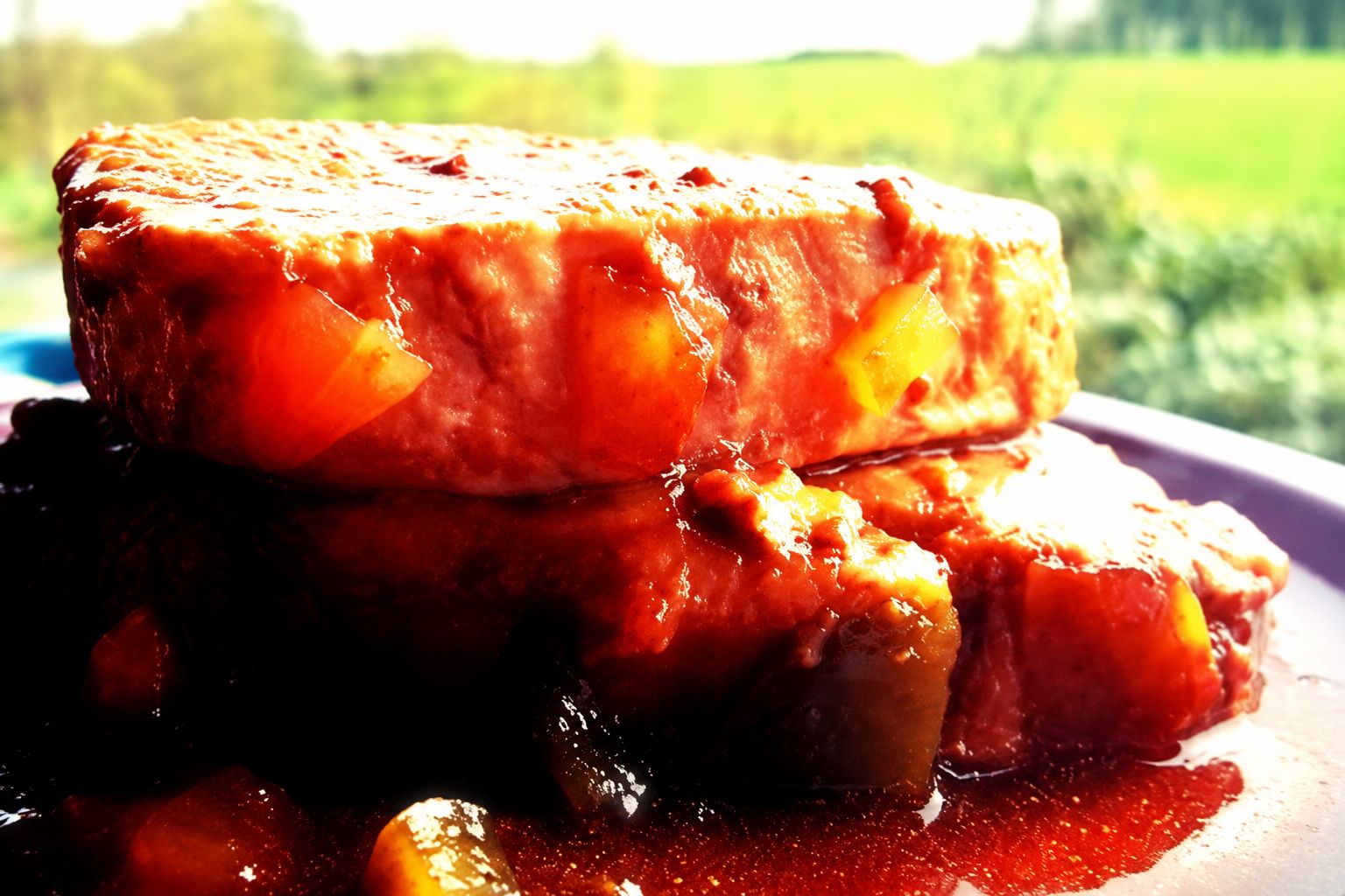 Saucy pork chops with peppers in a rich tomato glaze