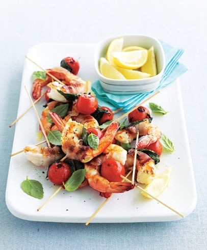 bacon wrapped dates stuffed with goat cheese on skewers