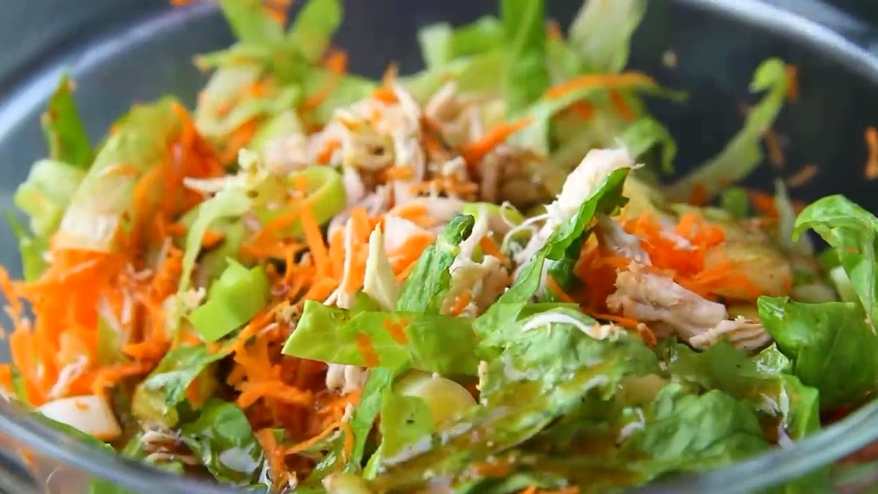 Dressing the chicken lettuce salad.
