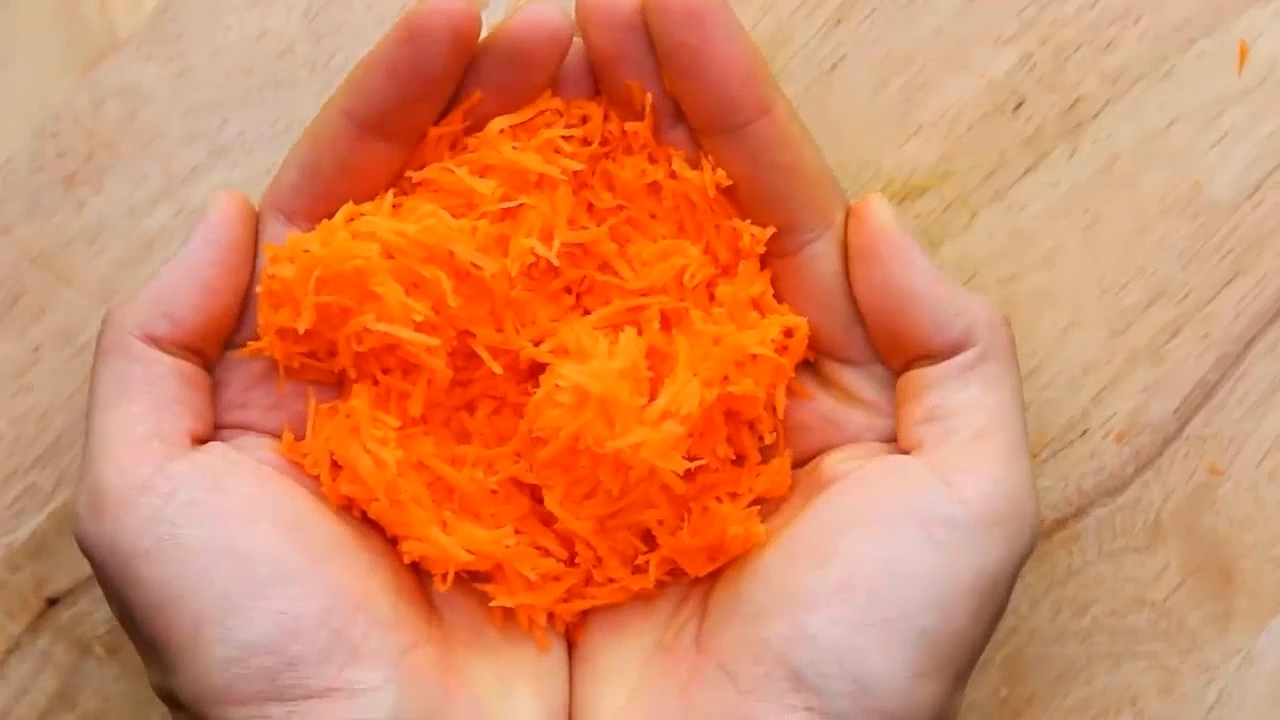 Grating carrot for chicken lettuce salad.