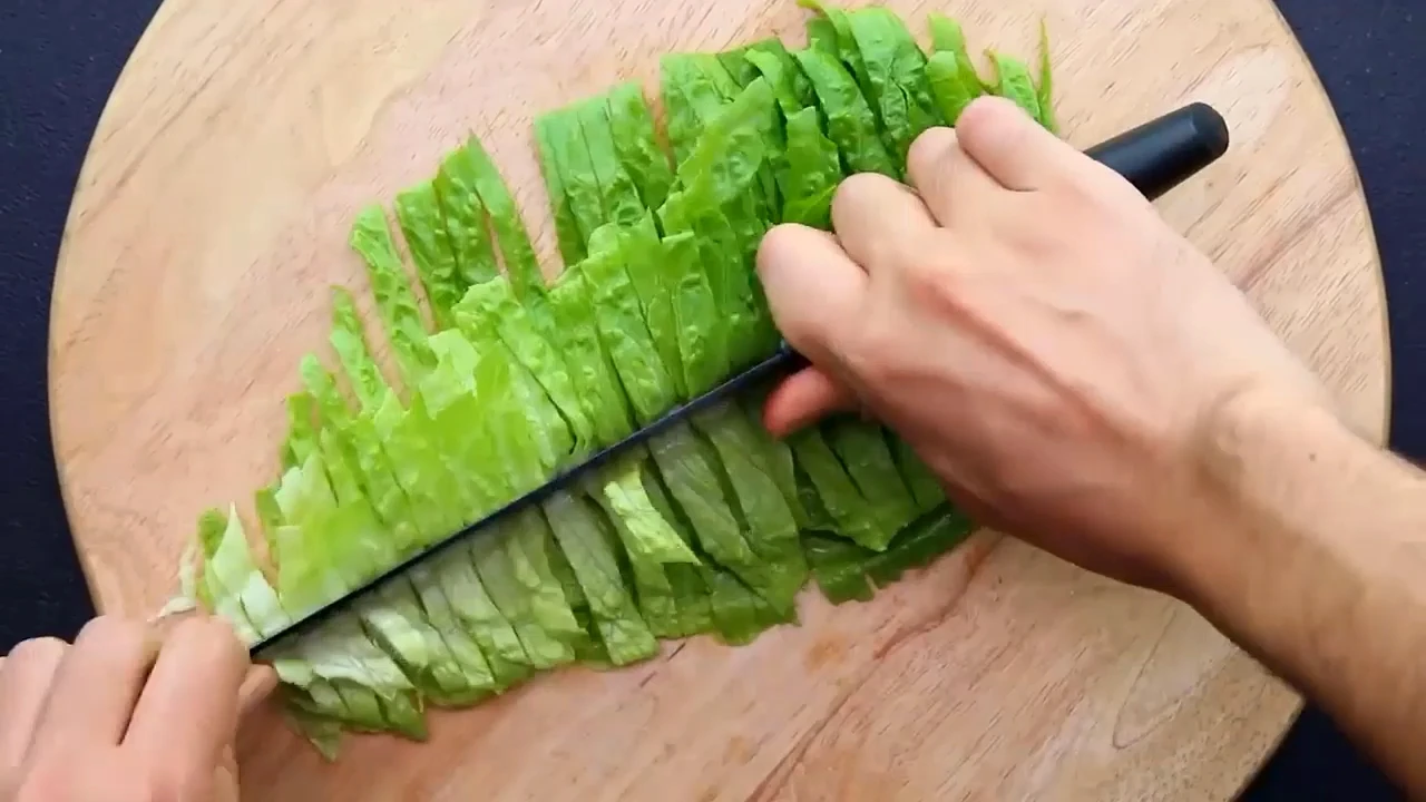 Slicing lettuce for chicken lettuce salad.