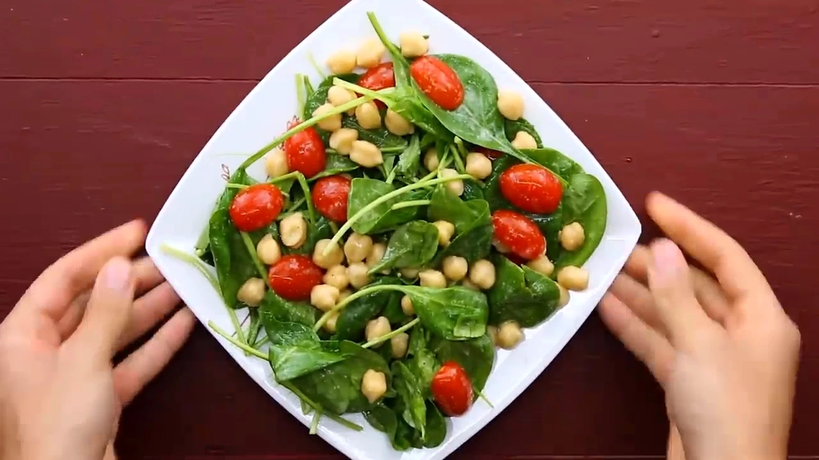 Chickpea spinach salad topped with sliced baked chicken