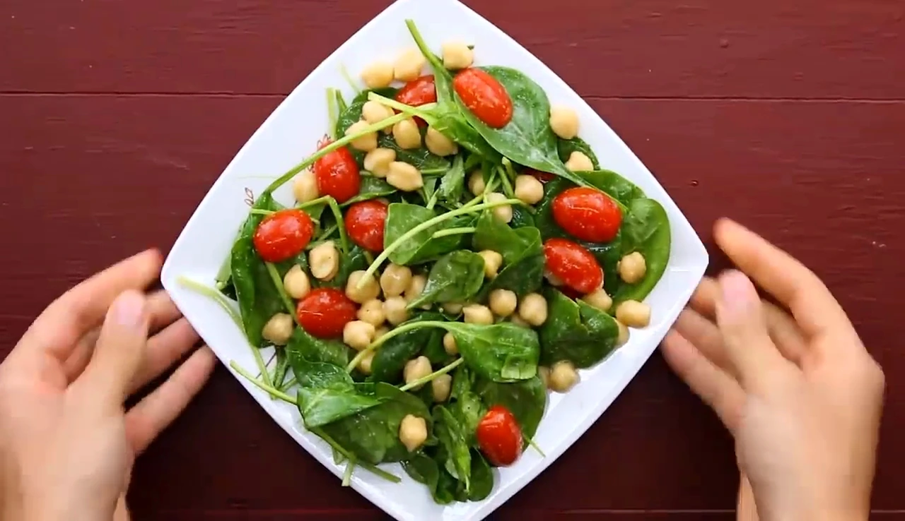 Plated chickpea spinach salad before adding chicken