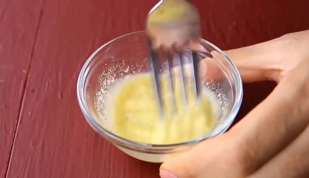 Whisking mustard dressing for chickpea spinach salad