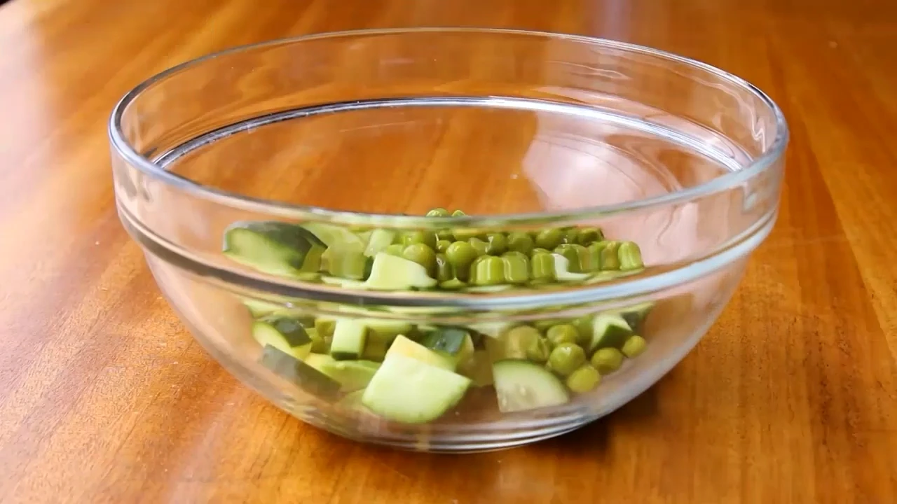 Avocado and cucumber going into a bowl for cucumber avocado salad.
