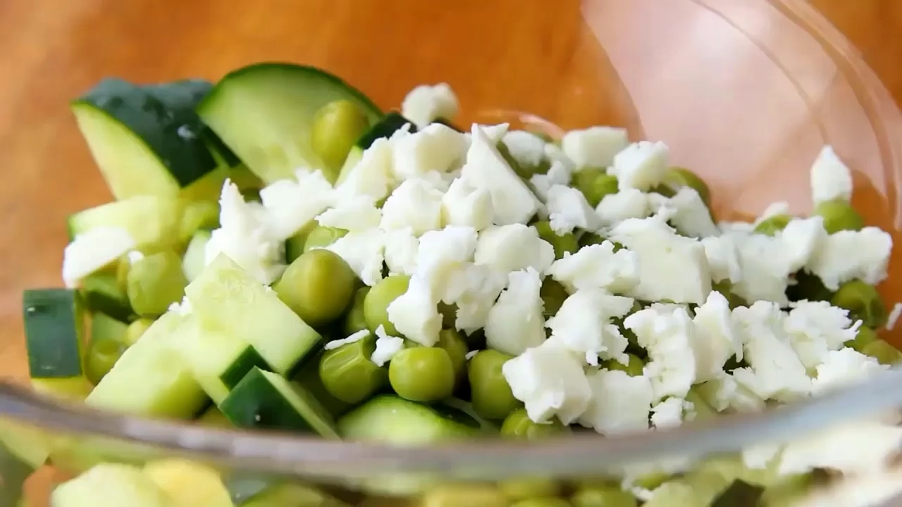 Dressing the cucumber avocado salad.