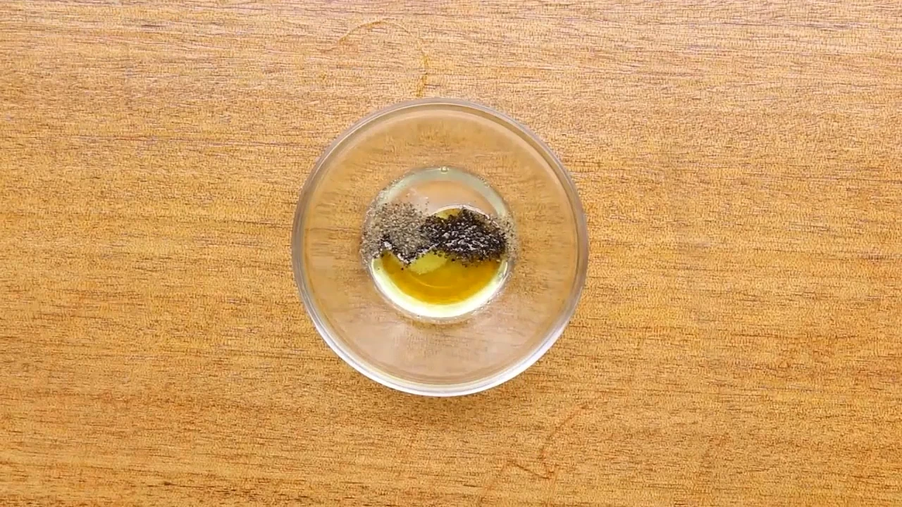 Seasoning the dressing with salt and black pepper.