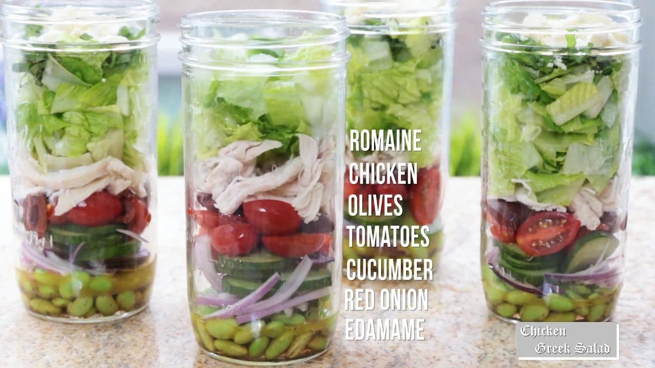 Adding chicken and romaine to salad jars.