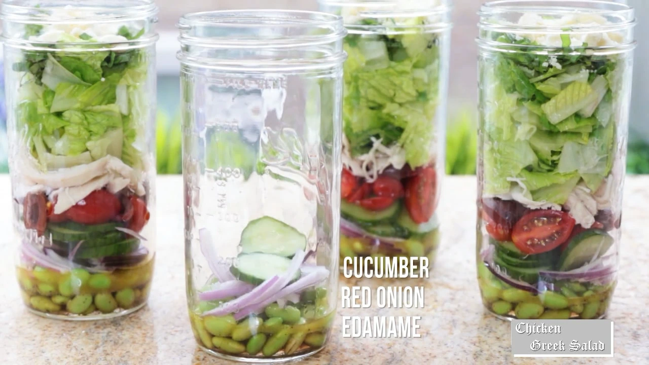 Layering red onion and cucumber into jars.