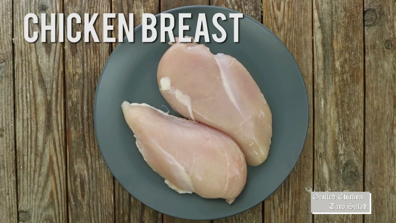 Seasoned chicken breasts for grilled chicken taco salad.
