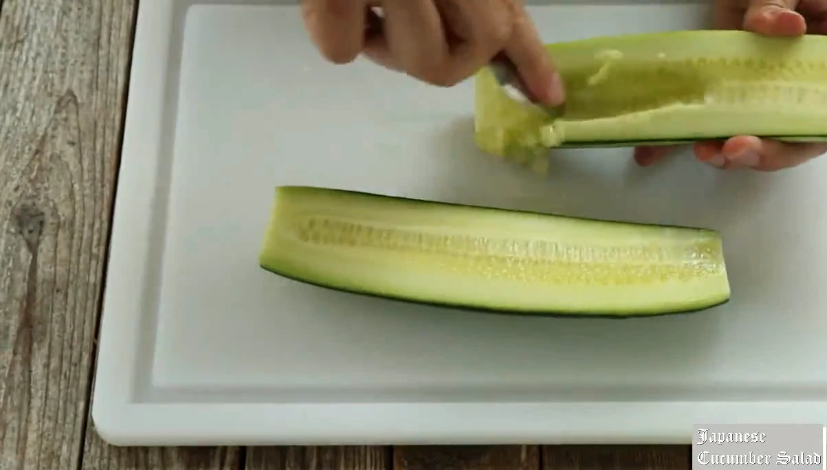 Scraping the seeds from the cucumber for Japanese cucumber salad.
