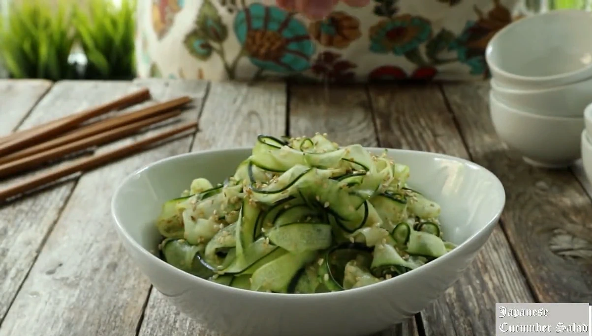 Japanese cucumber salad ready to serve in a white bowl.