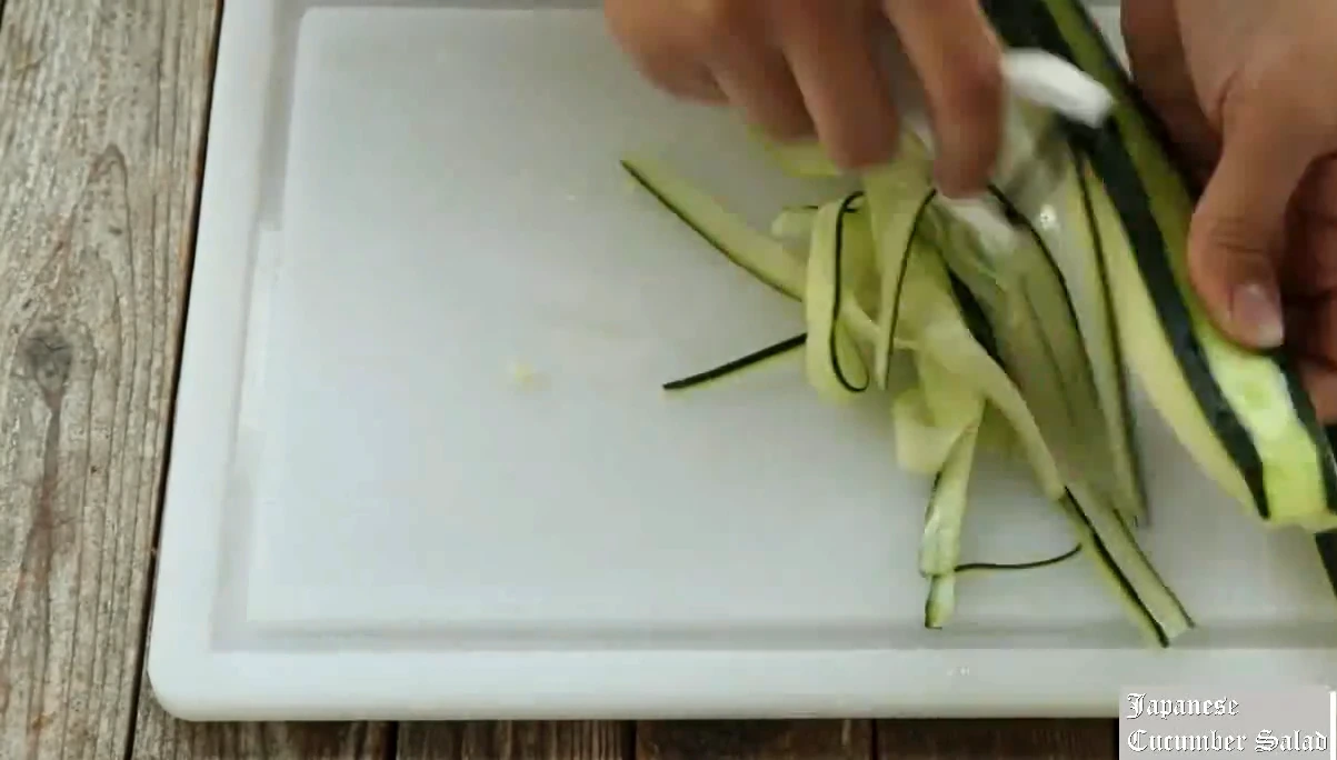 Shaving thin cucumber ribbons.