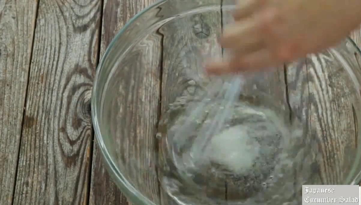 Whisking rice vinegar, salt, and sugar for Japanese cucumber salad.