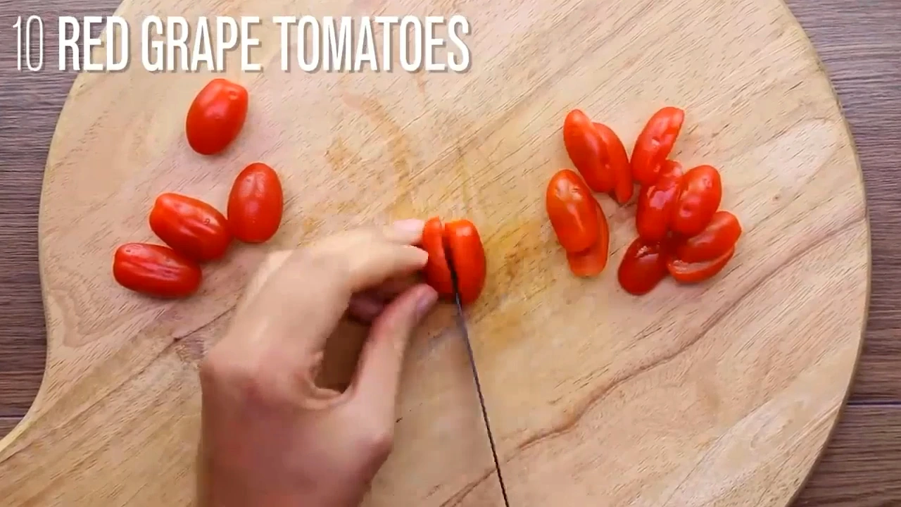 Corn, cucumber, tomatoes, and chicken being added to a meal prep container