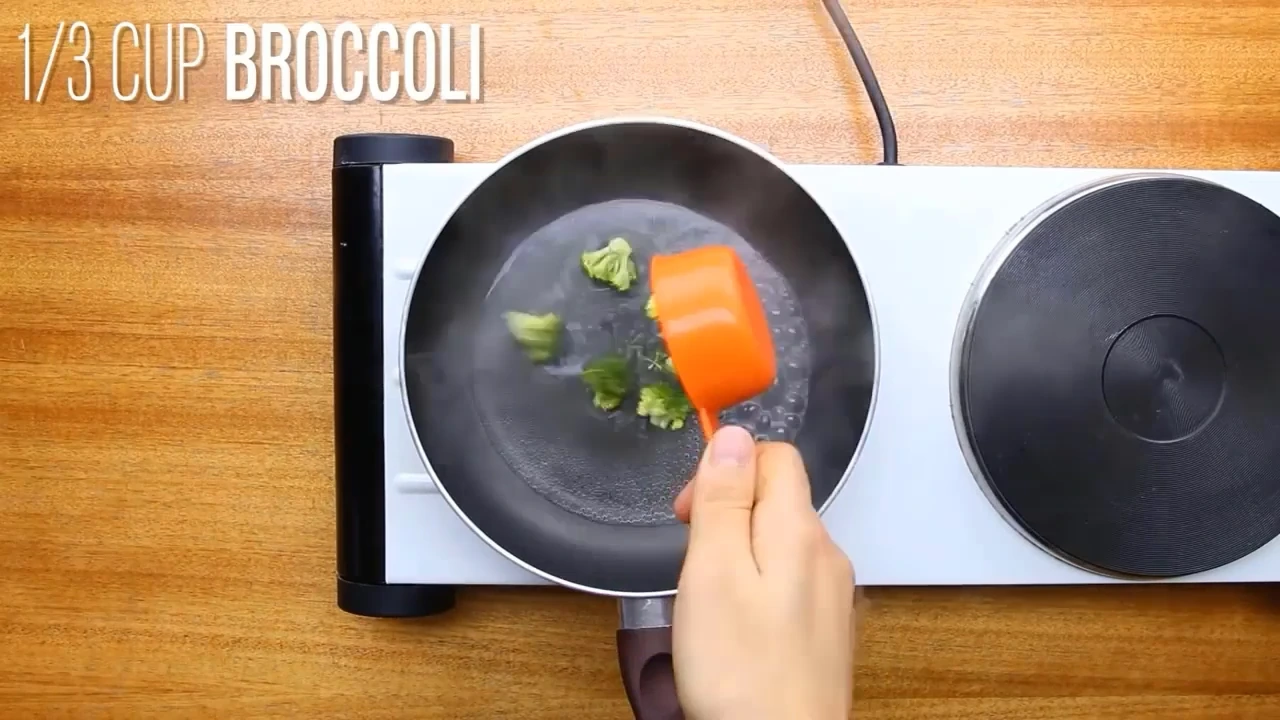 Cooking broccoli in a pan with water.