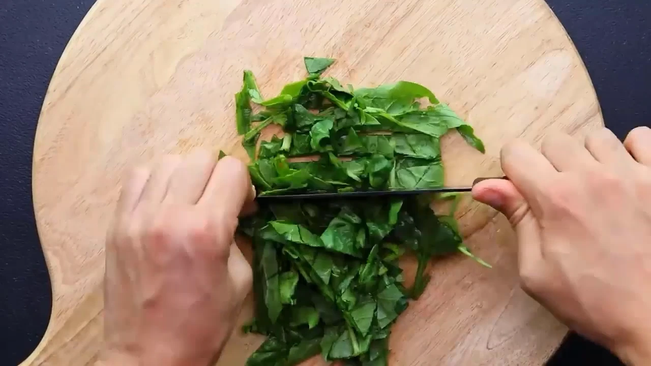 Chopping spinach for quinoa salad.