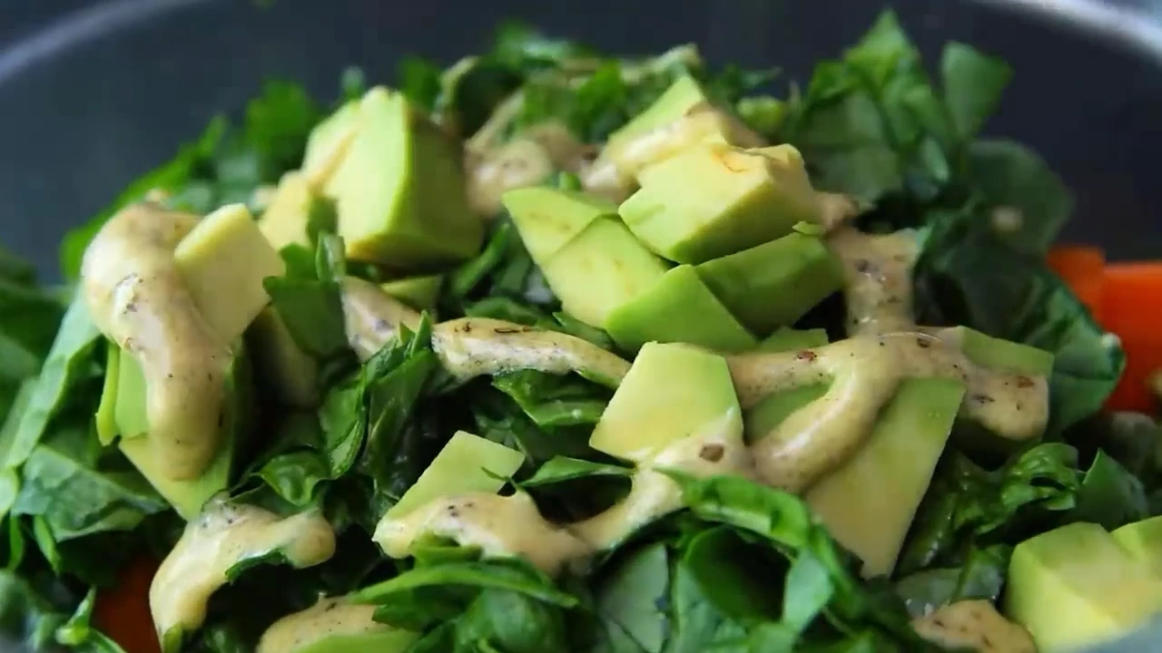 Adding dressing to quinoa salad.