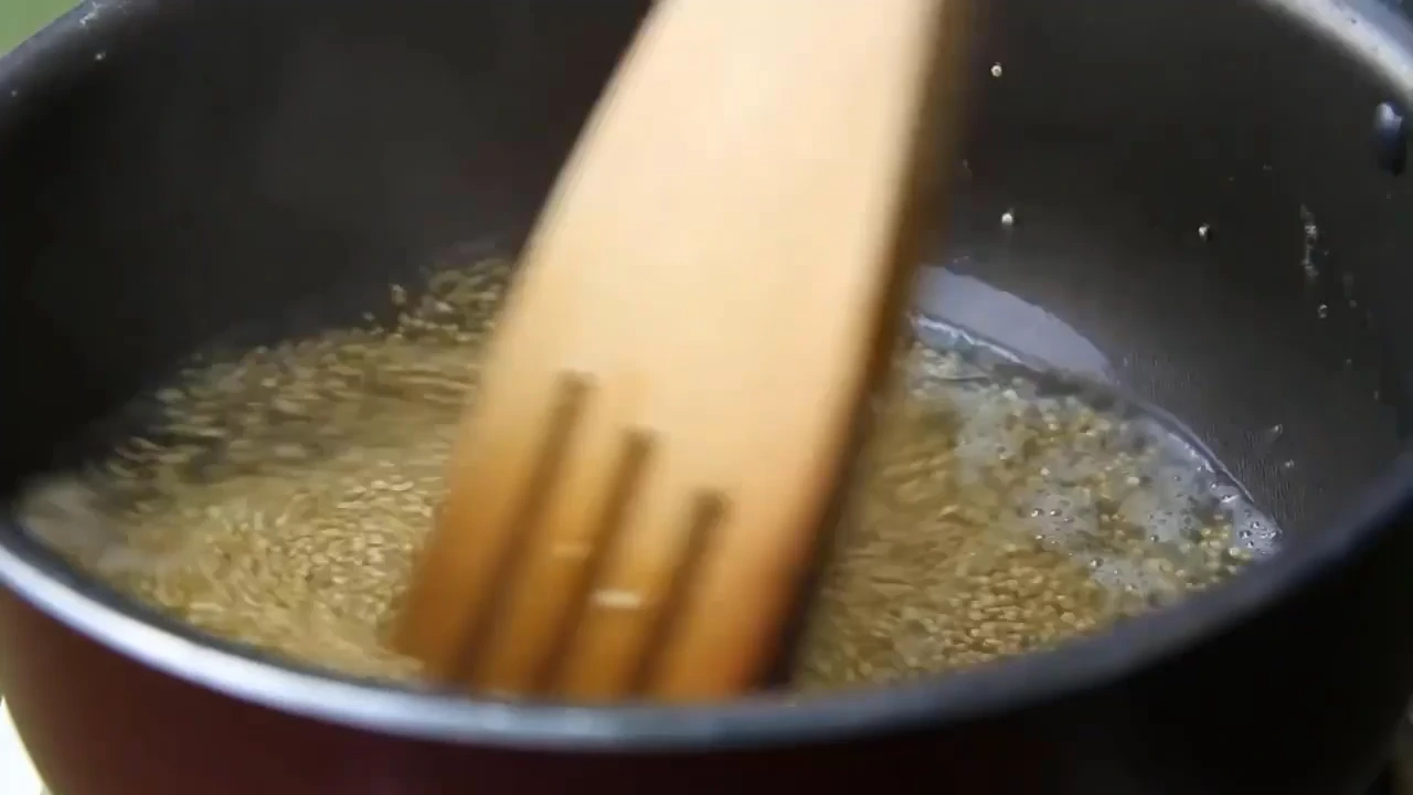 Cooking quinoa in a pot for quinoa salad with avocado.