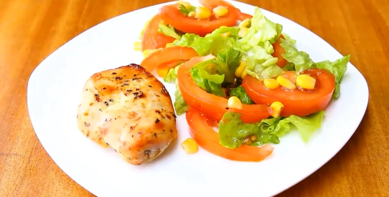 Plated roasted chicken salad with baked chicken breast.