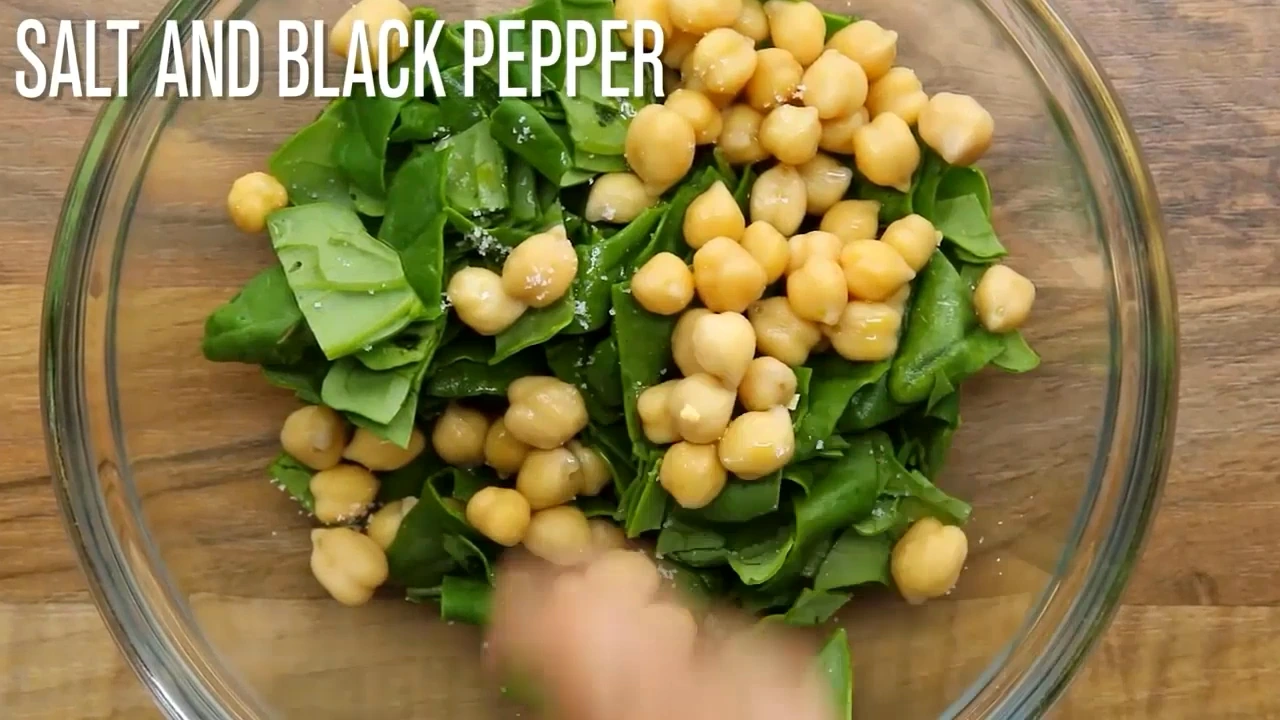 Seasoning and oil being added to the salad bowl