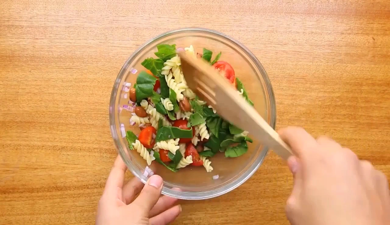 Tossing the pasta salad base