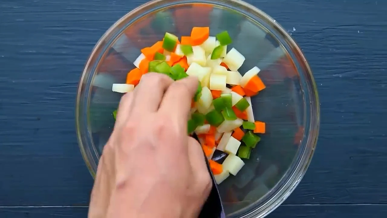Starting the spinach potato salad bowl with cooked vegetables and green pepper.