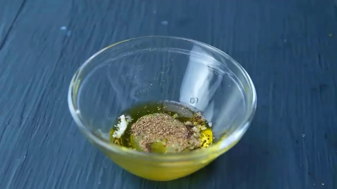 Whisking olive oil, salt, and black pepper for the salad.