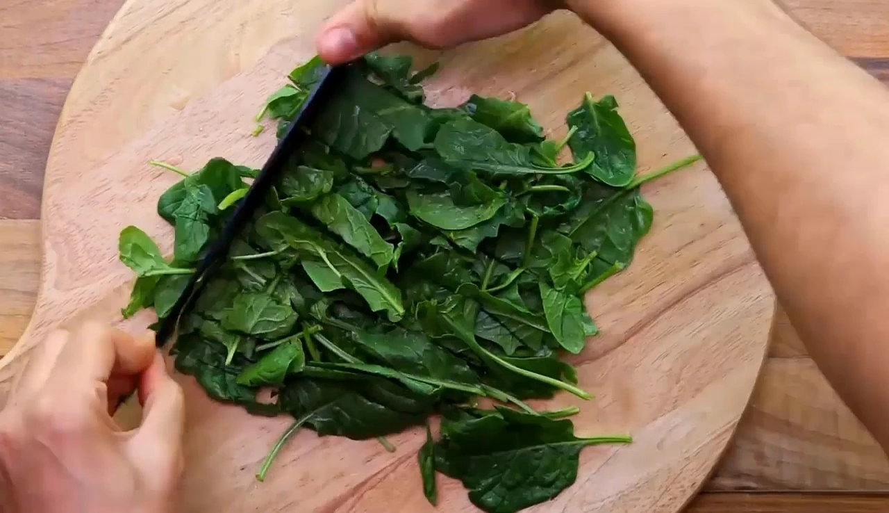 Chopping spinach for strawberry spinach salad