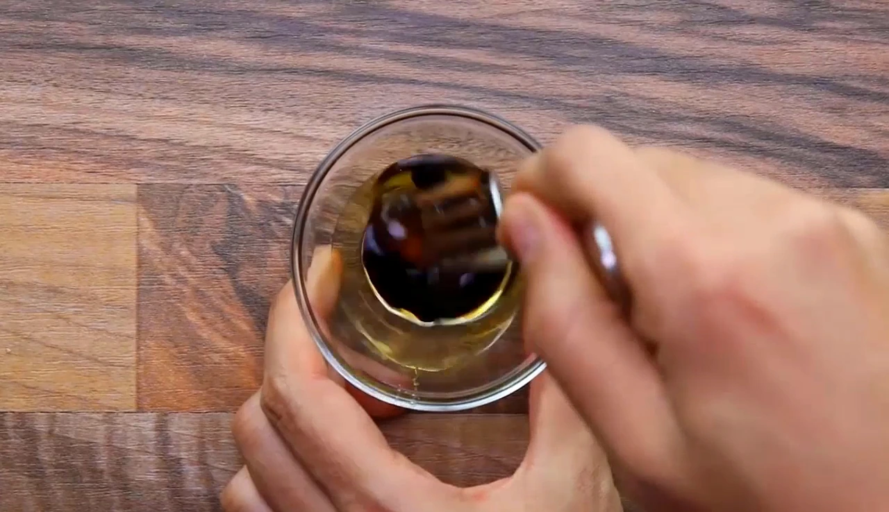 Whisking balsamic dressing for strawberry spinach salad
