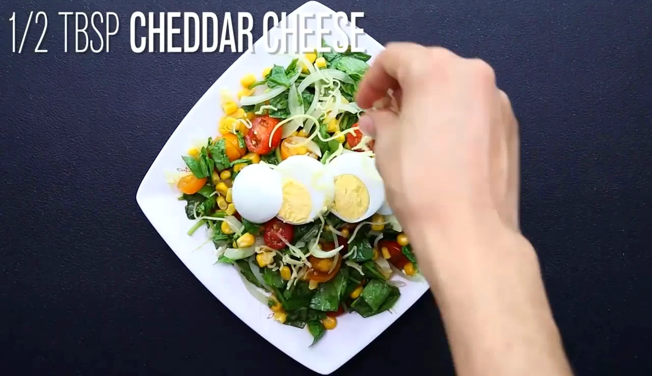 Finishing the salad with egg slices and cheddar