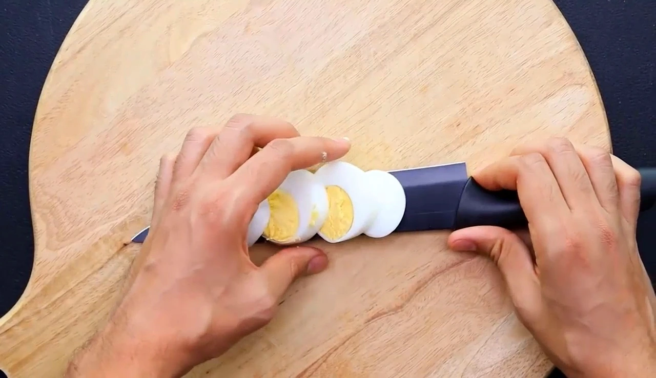 Slicing a boiled egg for the salad