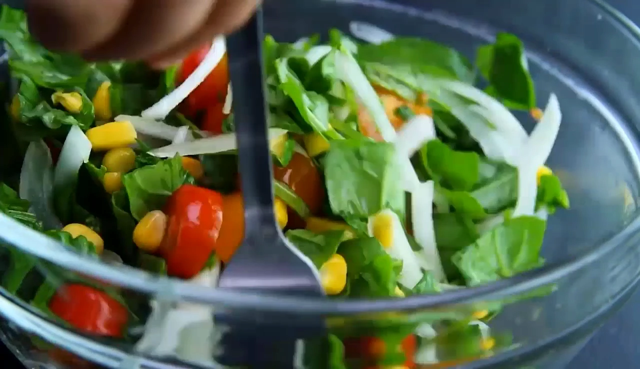 Adding corn to summer spinach and corn salad