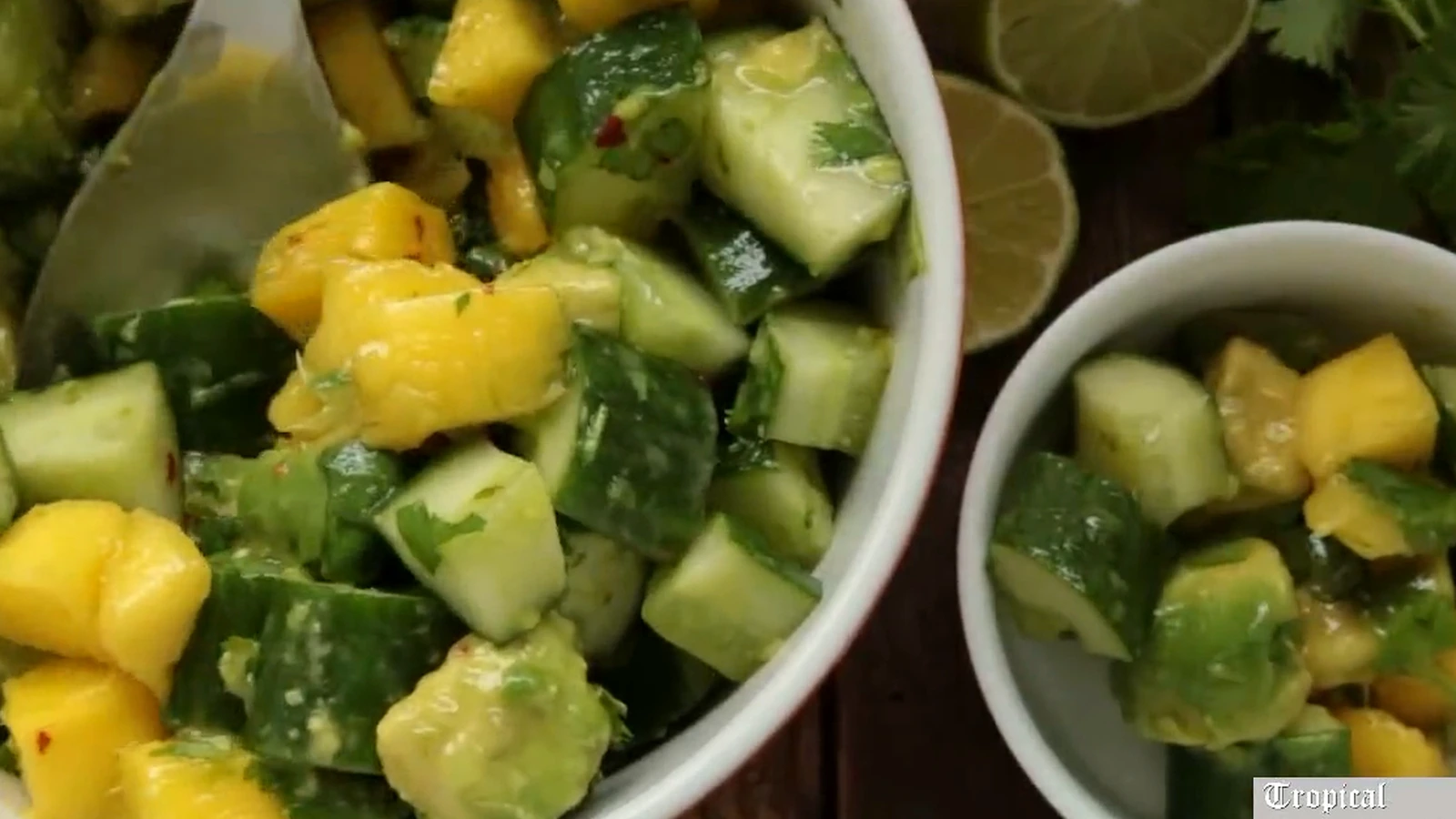 Tropical cucumber salad with mango and avocado in serving bowls.