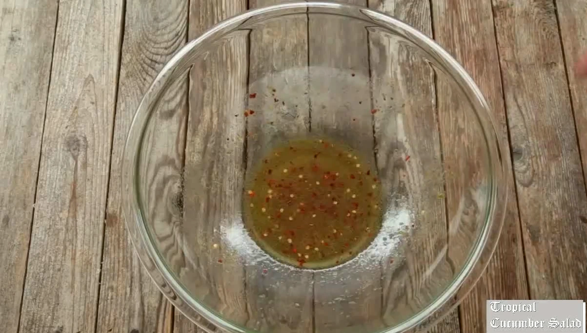 Whisking the fish sauce lime dressing for tropical cucumber salad.