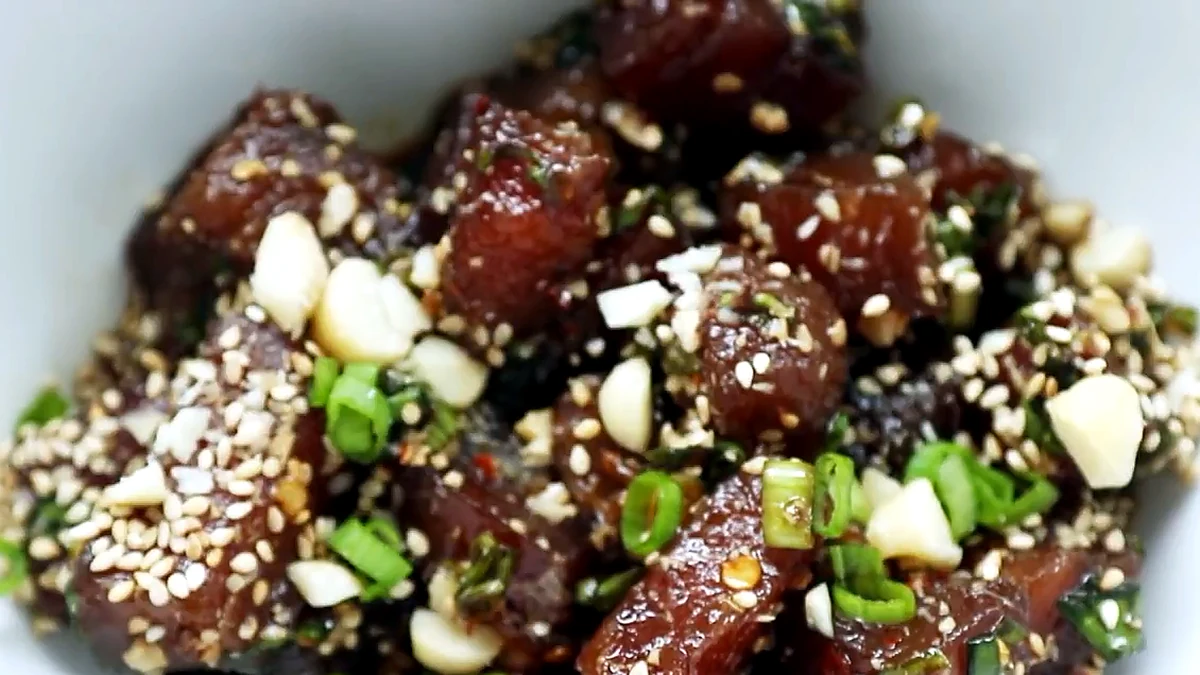 finished ahi poke in a bowl with sesame seeds and green onions