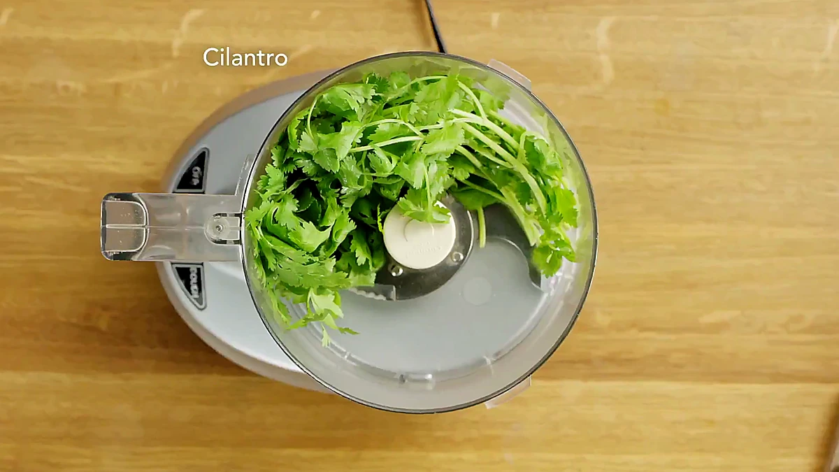 Cilantro added to a food processor for aji verde sauce