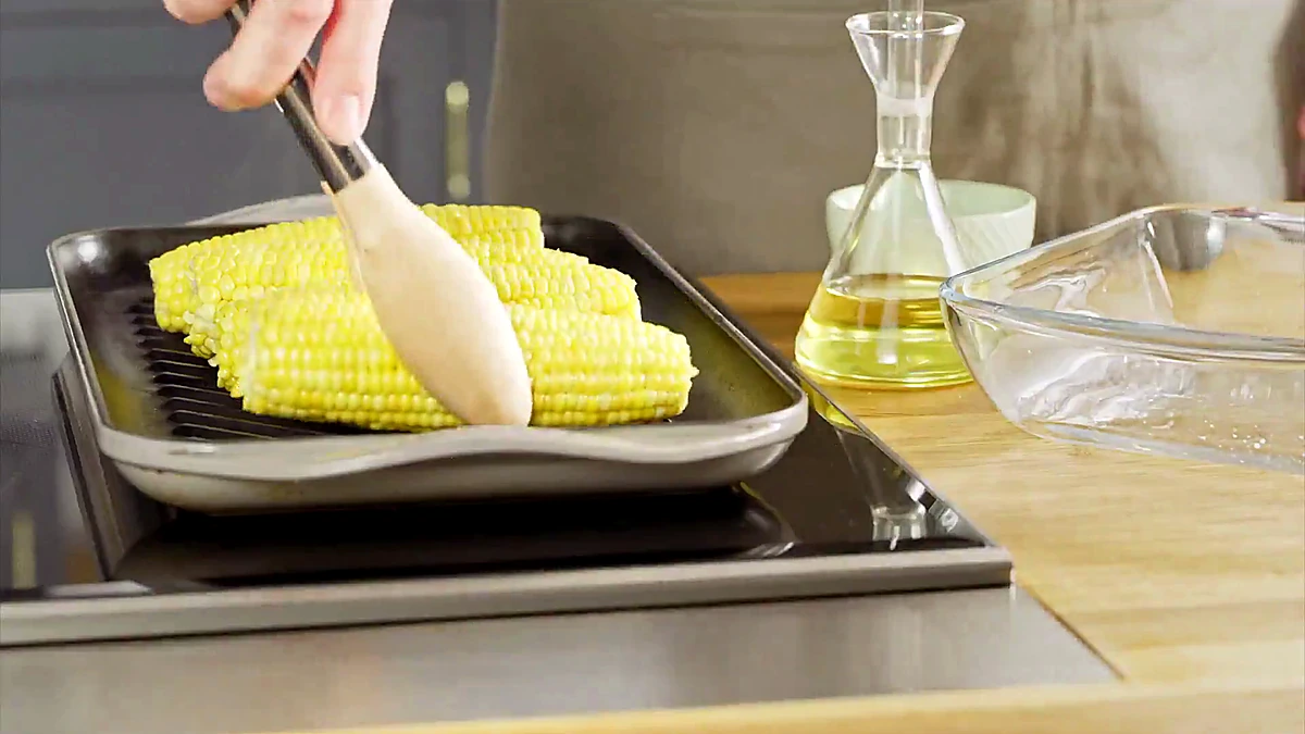 Corn brushed with olive oil before grilling