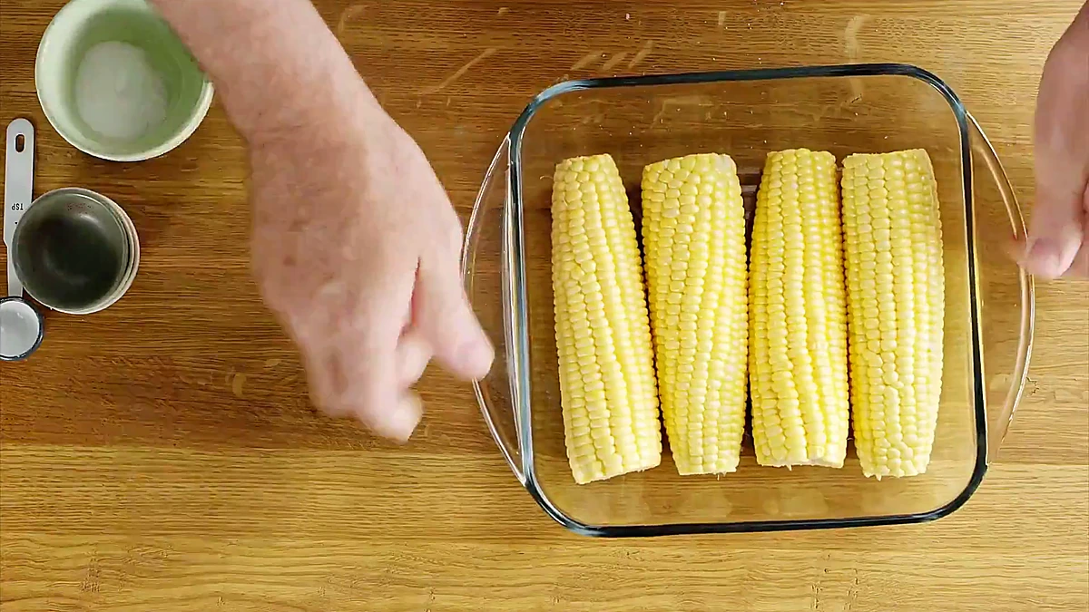 Fresh corn in a bowl with water before microwaving