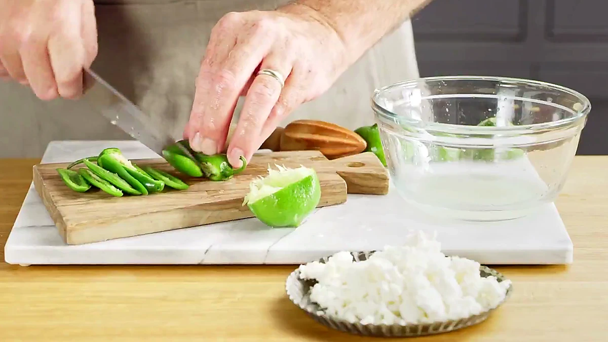 Jalapeno sliced beside lime and queso fresco