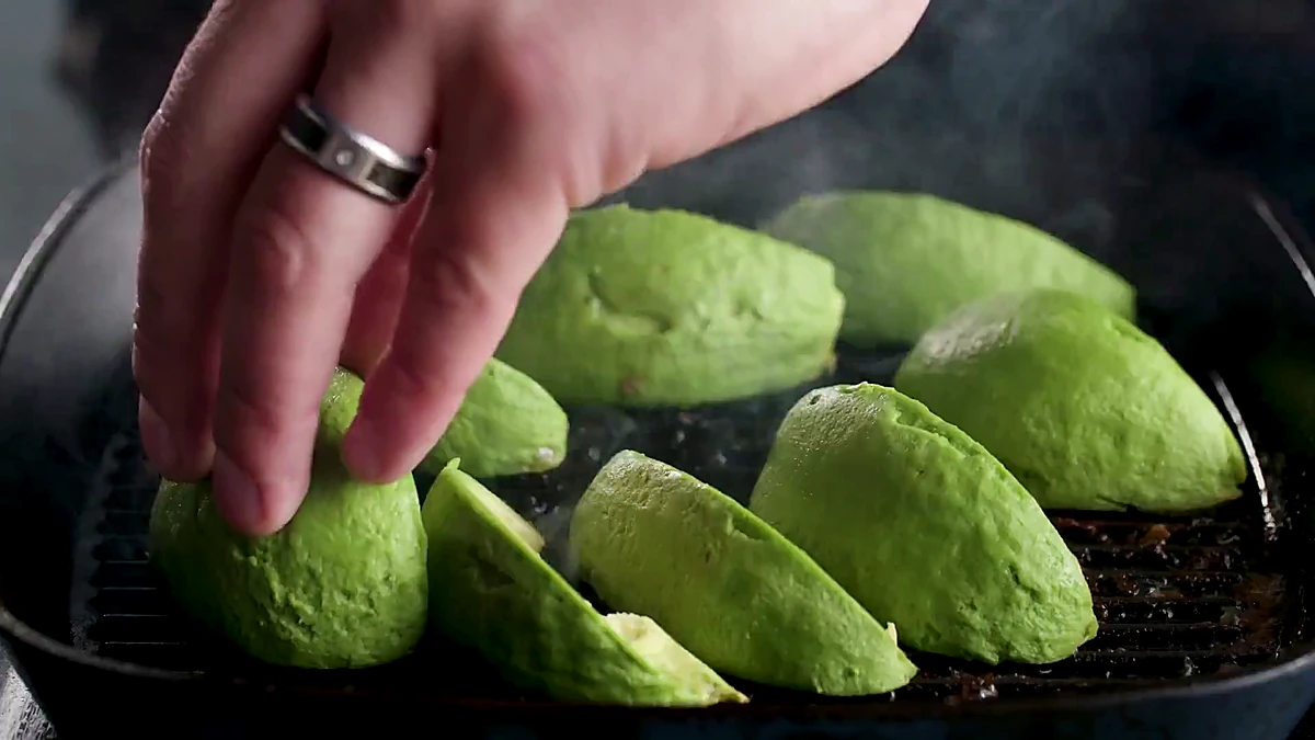Avocado quarters added to grill pan