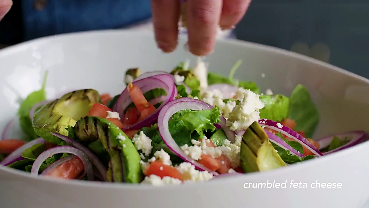 Feta crumbled over avocado salad