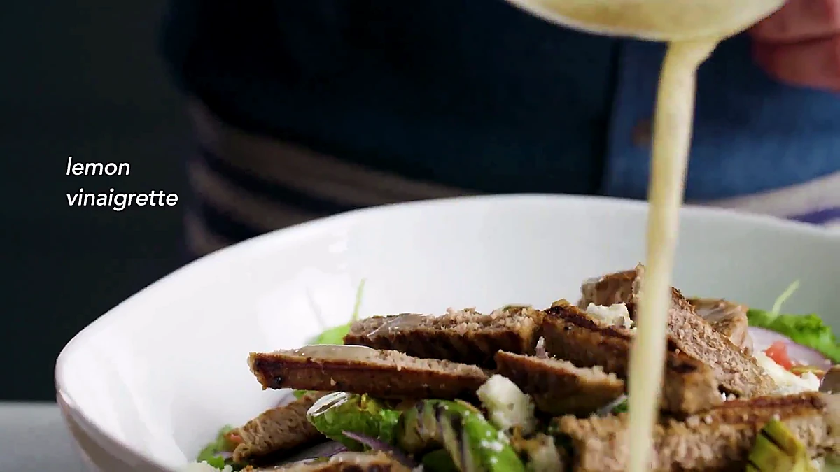 Lemon vinaigrette poured over turkey avocado salad