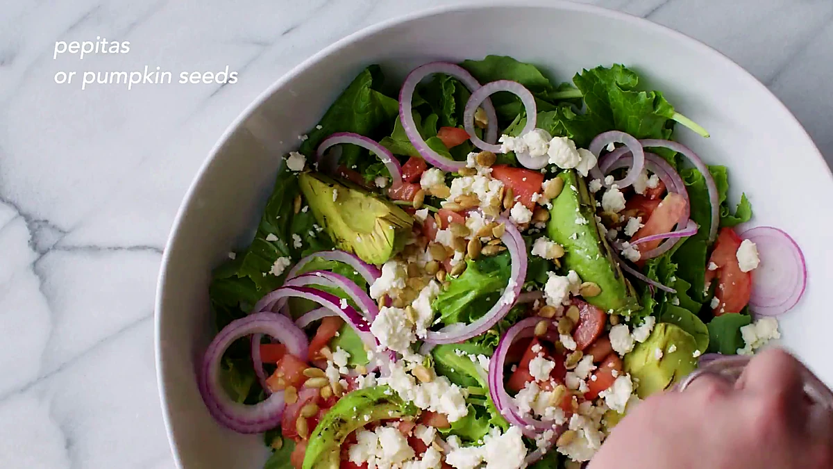 Pepitas sprinkled over avocado salad