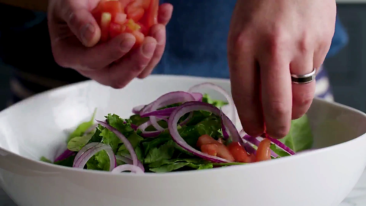 Chopped tomato added to greens