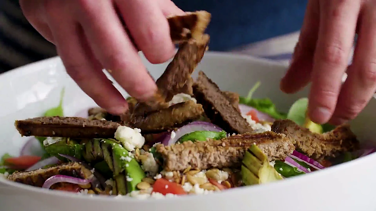 Sliced grilled turkey added to avocado salad