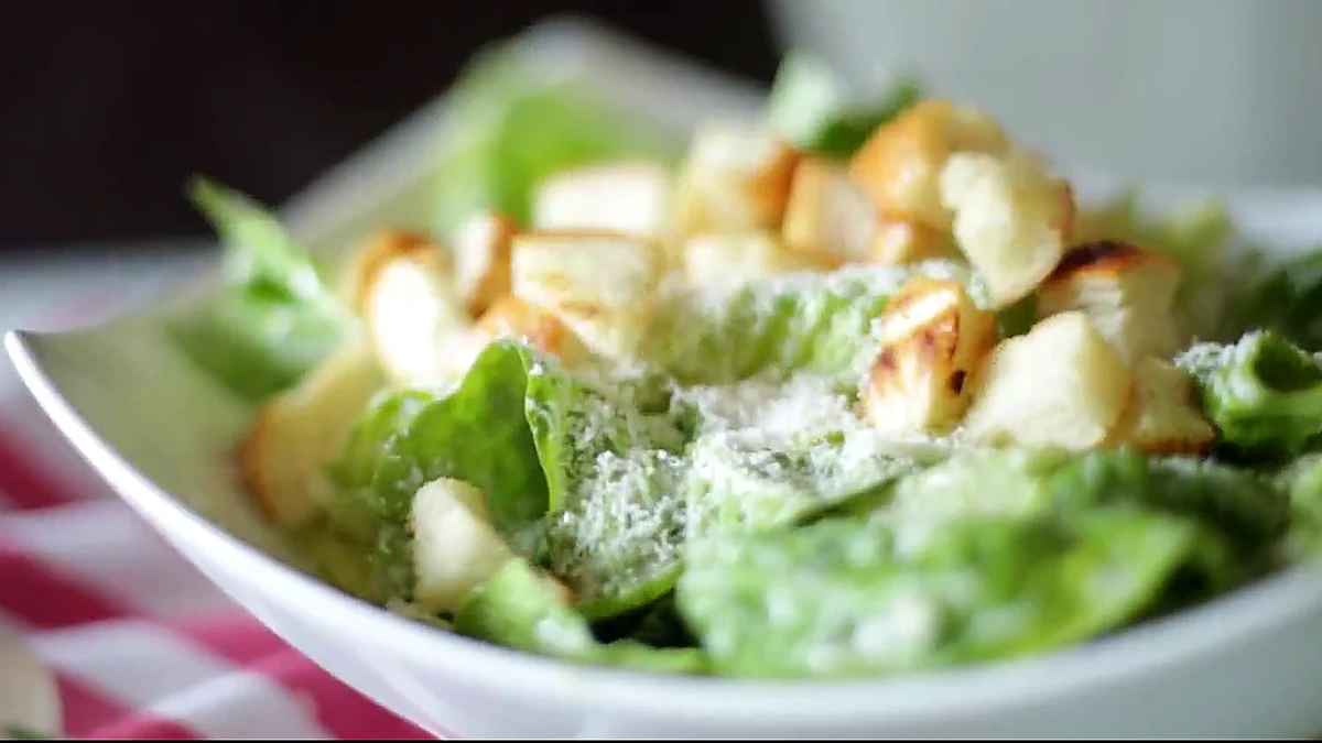 Golden croutons added to shrimp Caesar salad