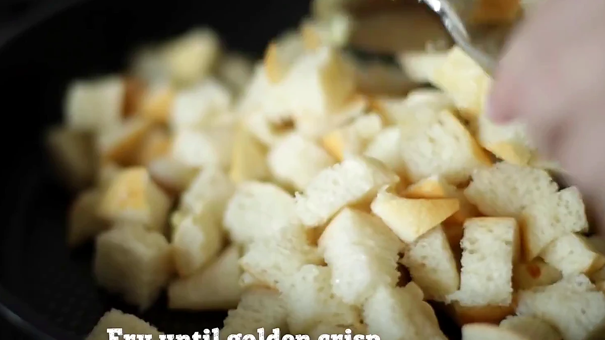 Baguette croutons frying in a pan